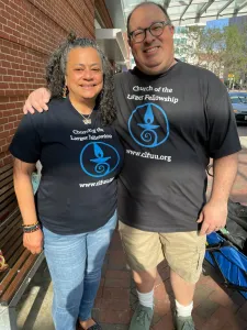 michael and aisha wearing matching CLF shirts smiling and looking at the camera